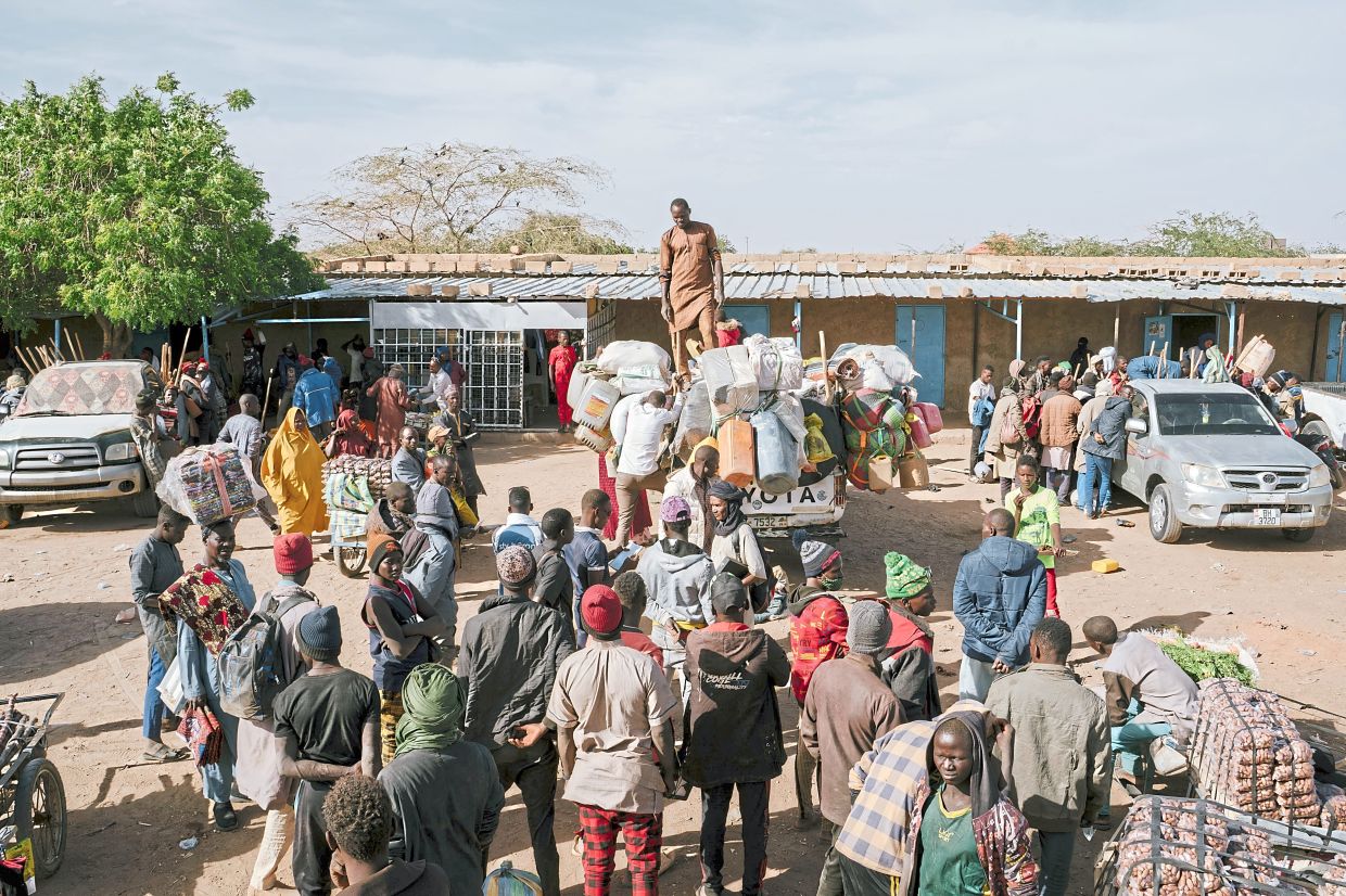 Men load a pickup truck before leaving for Libya from the newly reopened immigration outpost in Agadez, Niger. — ©2024 The New York Times Company