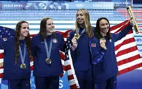 On a wild final night of swimming, US sets two world records and edges Australia in gold-medal race to remain top nation in sport
