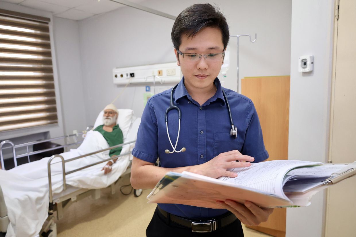 A young doctor, Consultant General Surgeon Dr Steven See Boon Keong treating a patient with care and efficiency at KPJ Sentosa Specialist Hospital in Kuala Lumpur. — FAIHAN GHANI/The Star