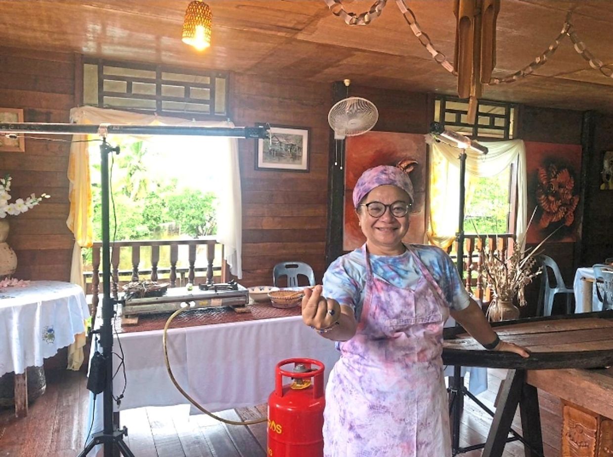 Diana looking comfortable in a batik linut apron, headwrap and T-shirt. 