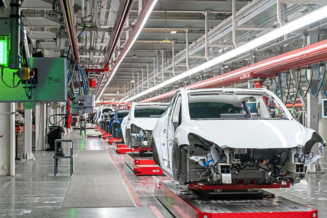 Unsurprising U-turn: Cars on the assembly line at Tesla’s Giga Texas manufacturing facility in Austin. Musk has opted against investing in Malaysia, Indonesia and Thailand after months of aggressive courting by leaders of these countries of his EV brand. — AFP