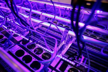 FILE PHOTO Cryptocurrency miners are seen in a liquid immersion cooling mining tank at the TMG Core stand during the Bitcoin Conference 2022 in Miami Beach Florida U.S. April 6 2022. REUTERSMarco BelloFile Photo
