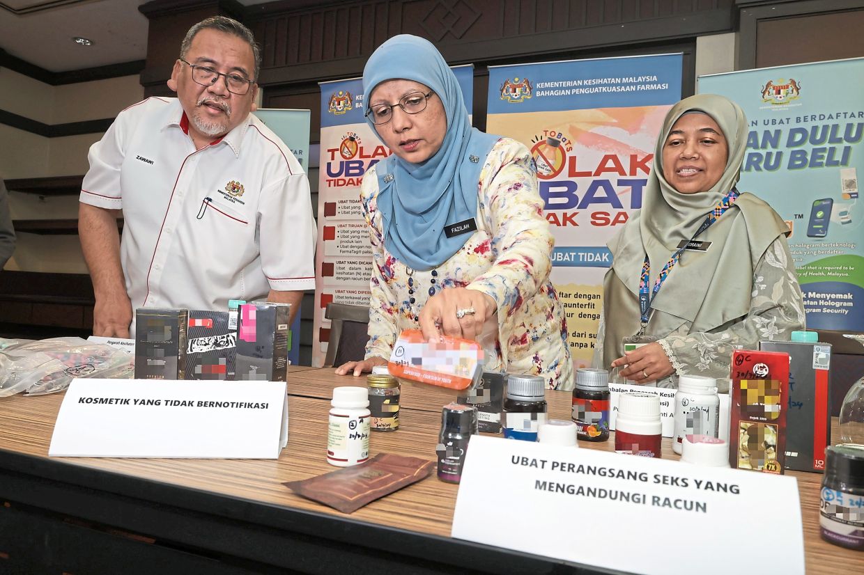 Unnotified cosmetics and unregistered sex stimulants that have been seized being displayed at a press conference by (from left) Pharmacy Enforcement Division director Mohd Zawawi Abdullah, Penang state health director Datuk Dr Fazilah Shaikh Allaudin and state health deputy director (pharmacy) Noraini Ab Kadir in George Town recently. — CHAN BOON KAI/The Star