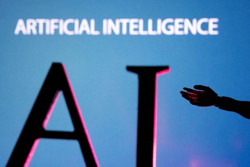 FILE PHOTO AI Artificial Intelligence letters and robot hand miniature in this illustration taken June 23 2023. REUTERSDado RuvicIllustrationFile Photo