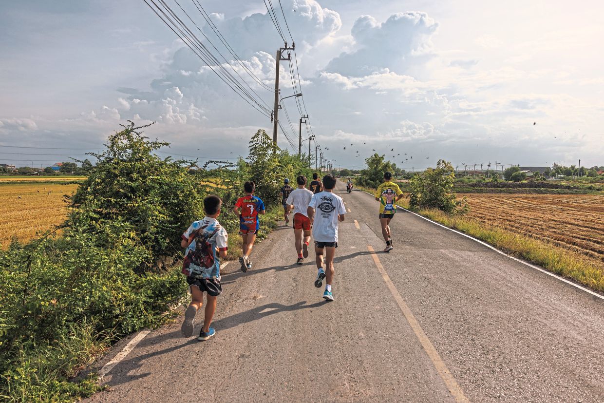 Children warming up with a 10km run before and after school. — ©2024 The New York Times Company