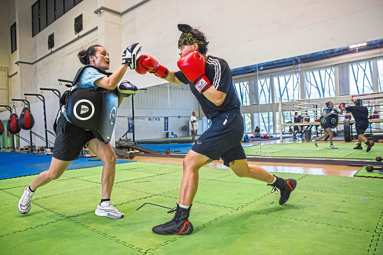 Thananya (right) training in a gym in Bangkok, Thailand. — ©2024 The New York Times Company