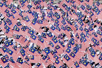 Performers waving the Jalur Gemilang on the 67th Merdeka Day celebration at Putrajaya on Saturday. — IZZRAFIQ ALIAS/The Star