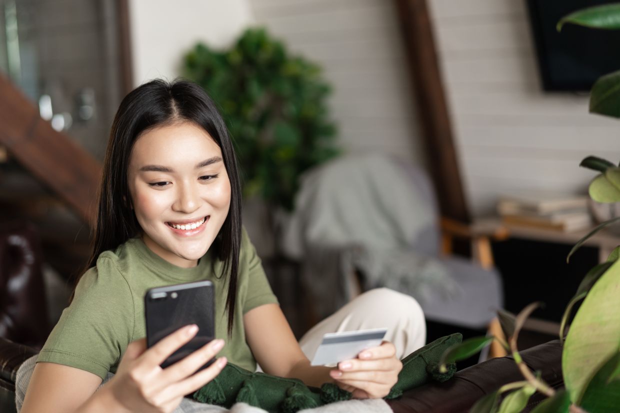 a hrefhttpswww.freepik.comfree-photosmiling-asian-girl-sitting-home-with-mobile-phone-credit-card-order-online-shop-paying21601121.htmfromViewsearchpage1position1uuidecc6f004-65ae-4b1f-a158-0ca6b558bcc1Image by benzoix on Freepika