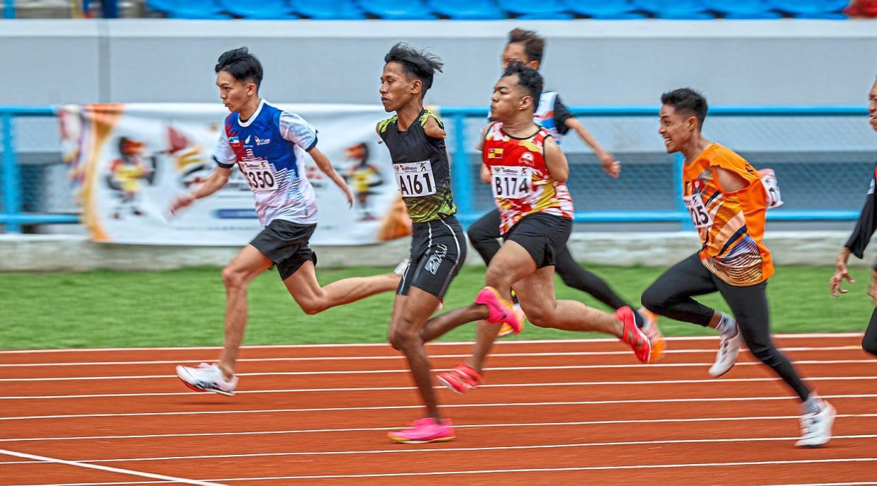 How fast can you go?: The runners in the men’s 100m T45 final dashing towards the finish line. — ZULAZHAR SHEBLEE / The Star