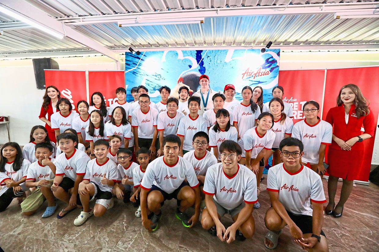 One for the album: Olympics swimming silver medallist Ben Proud posing with the Team Q Swimming Academy. — LOW LAY PHON/The Star