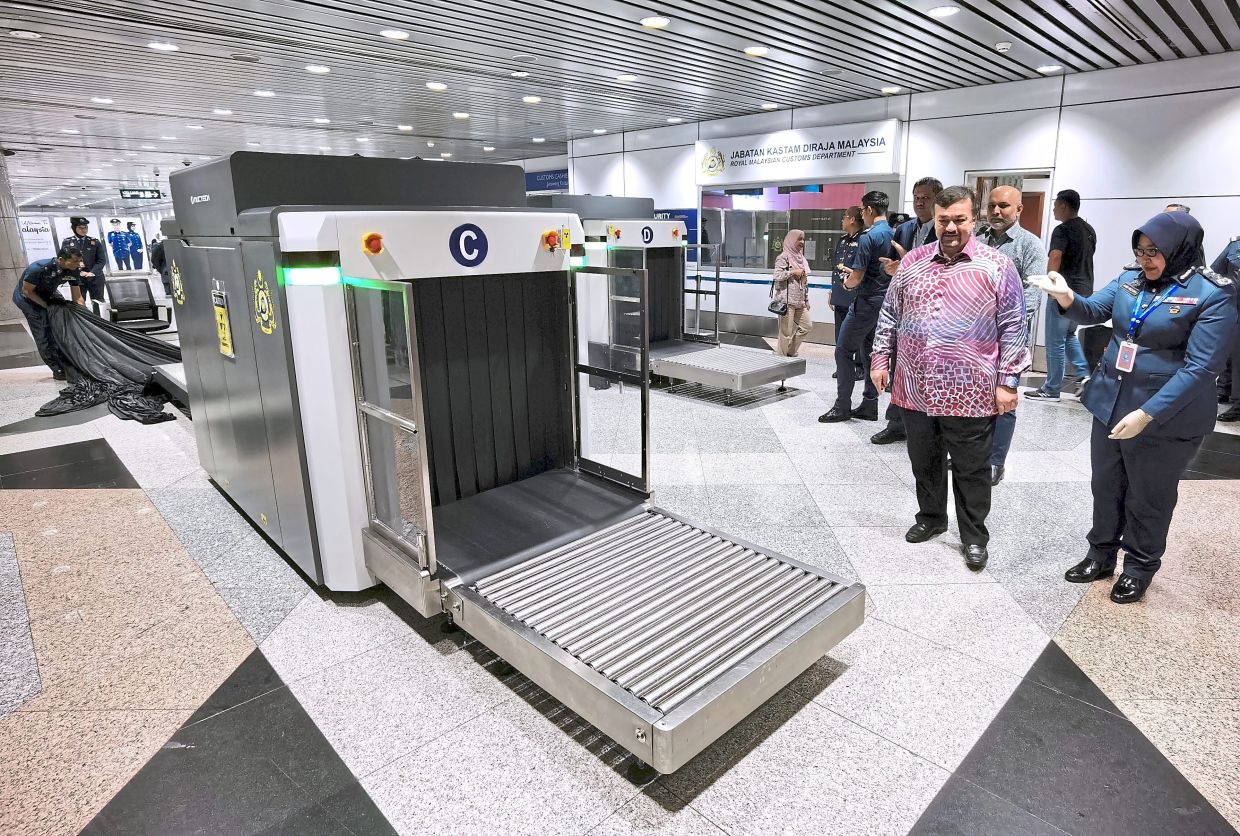 Anis Rizana accompanying Finance Minister II Datuk Seri Amir Hamzah Azizan to inspect the AI-equipped baggage scanner at KLIA Terminal 1 recently. — Bernama