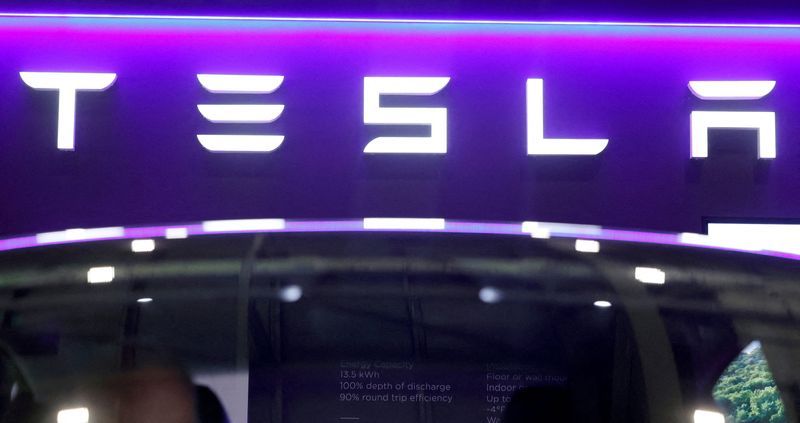 FILE PHOTO The logo of Tesla on display at the Everything Electric exhibition at the ExCeL London international exhibition and convention centre in London Britain March 28 2024.  REUTERSPeter CziborraFile Photo