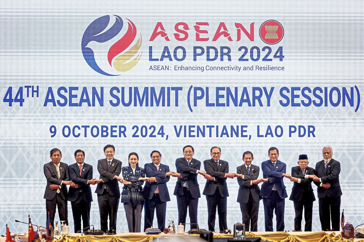 Strong united front: (From left) Myanmar’s Permanent Secretary of Foreign Affairs Aung Kyaw Moe, Marcos Jr, Wong, Paetongtarn, Pham, Siphandone, Anwar, Sultan Hassanal Bolkiah, Cambodian Prime Minister Hun Manet, Ma’ruf Amin and Gusmao standing hand-in-hand during a photocall of Asean leaders at the 44th Asean Summit (Plenary Session) at the National Convention Centre in Vientiane. — Bernama