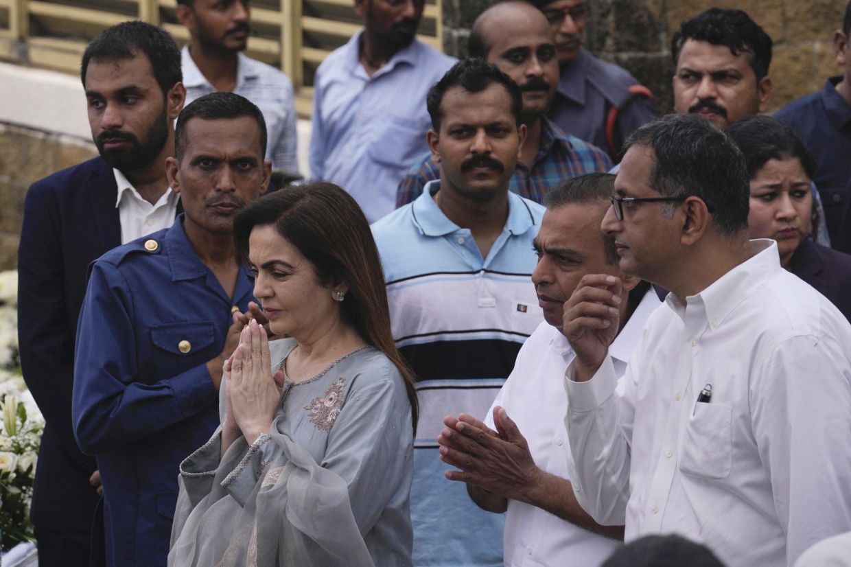 Indian industrialist Mukesh Ambani and his wife Nita Ambani arriving to pay their respects to Ratan Tata. - AP