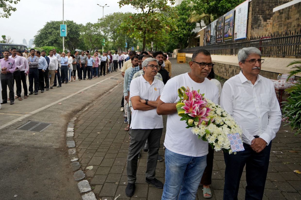 People waiting in queues outside the National Centre for the Performing Arts (NCPA), to pay their respects. - Reuters