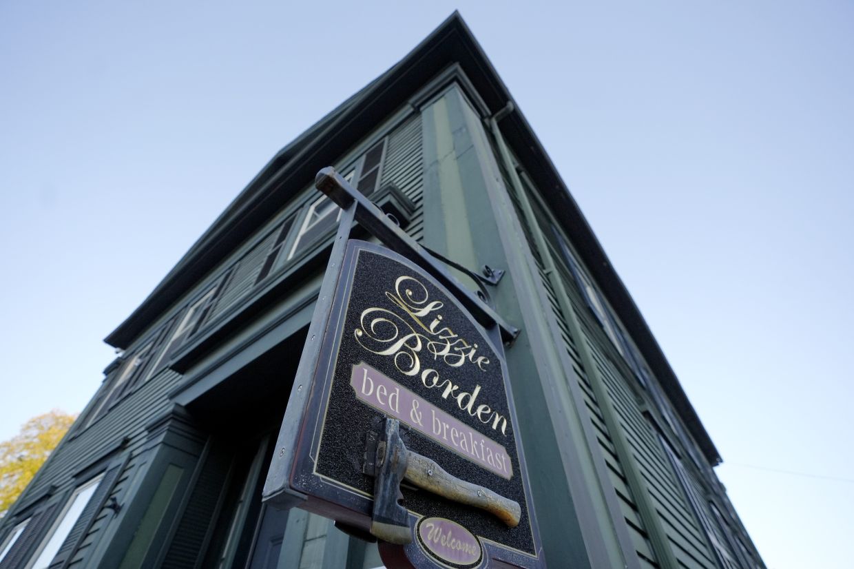 A sign featuring an axe hangs outside the Lizzie Borden House in Fall River Massachusetts in the US Photos AP