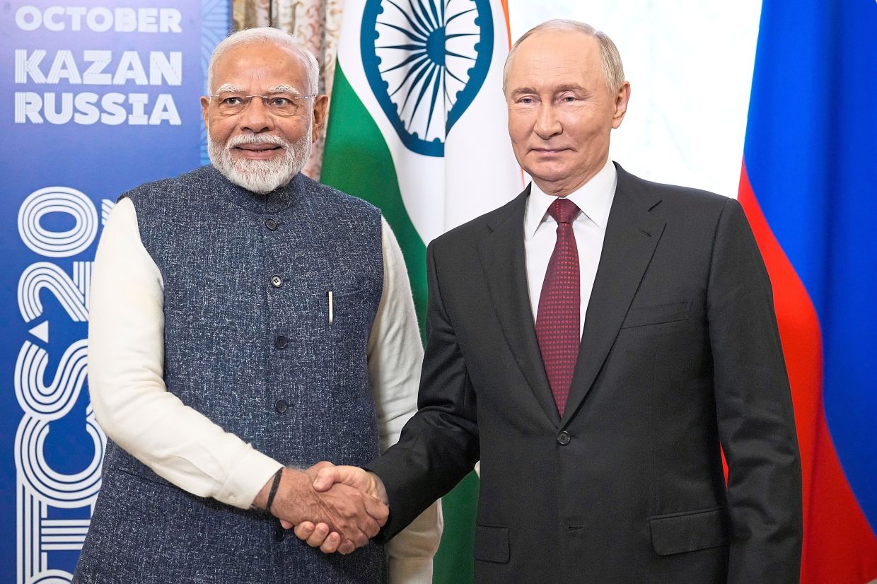 The new guard: Russian President Vladimir Putin and Indian Prime Minister Narendra Modi shaking hands during their meeting on the sidelines of BRICS Summit in Kazan in October. — AP