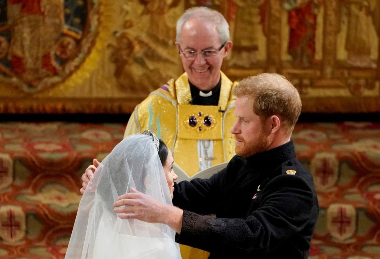 Prince Harry and Meghan Markle in St George's Chapel at Windsor Castle during their wedding service, conducted by the Archbishop of Canterbury Justin Welby in Windsor, Britain, May 19, 2018. Photo: Reuters
