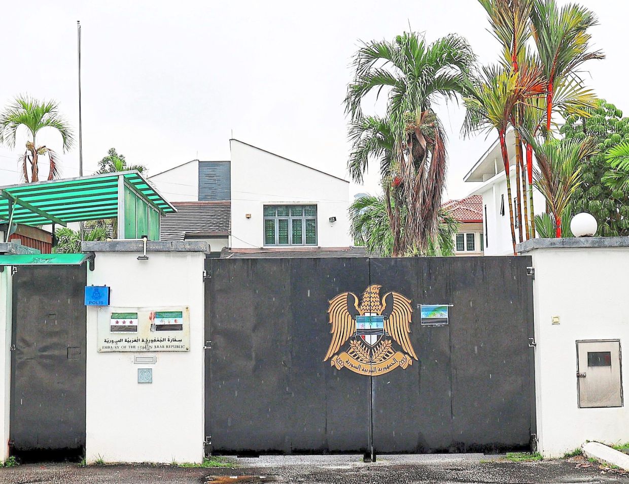 Strong sentiments: The empty flag pole at the Syrian Embassy in Kuala Lumpur after the national flag was taken down and the rebel flag plastered on the entrance. — MUHAMAD SHAHRIL ROSLI/The Star
