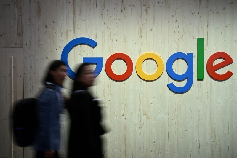 FILE PHOTO People walk next to a Google logo during a trade fair in Hannover Messe in Hanover Germany April 22 2024.  REUTERSAnnegret HilseFile Photo