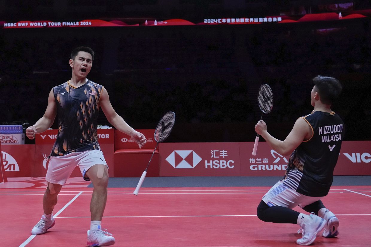 Goh Sze Fei and Nur Izzuddin of Malaysia celebrate after defeating Fajar Alfian and Muhammad Rian Ardianto of Indonesia in the men's doubles badminton semifinals match at the World Tour Finals in Hangzhou in east China's Zhejiang province, Saturday, Dec. 14, 2024. - AP Photo/Andy Wong