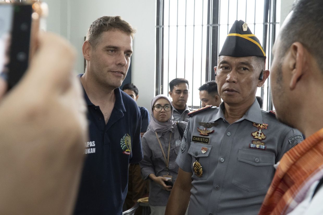 Australian Matthew Norman (black shirt), a member of the Bali Nine group and serving life sentences for drug smuggling, talks with Indonesian representative council at Kerobokan prison in Bali, Indonesia Friday, Dec. 6, 2024. - AP