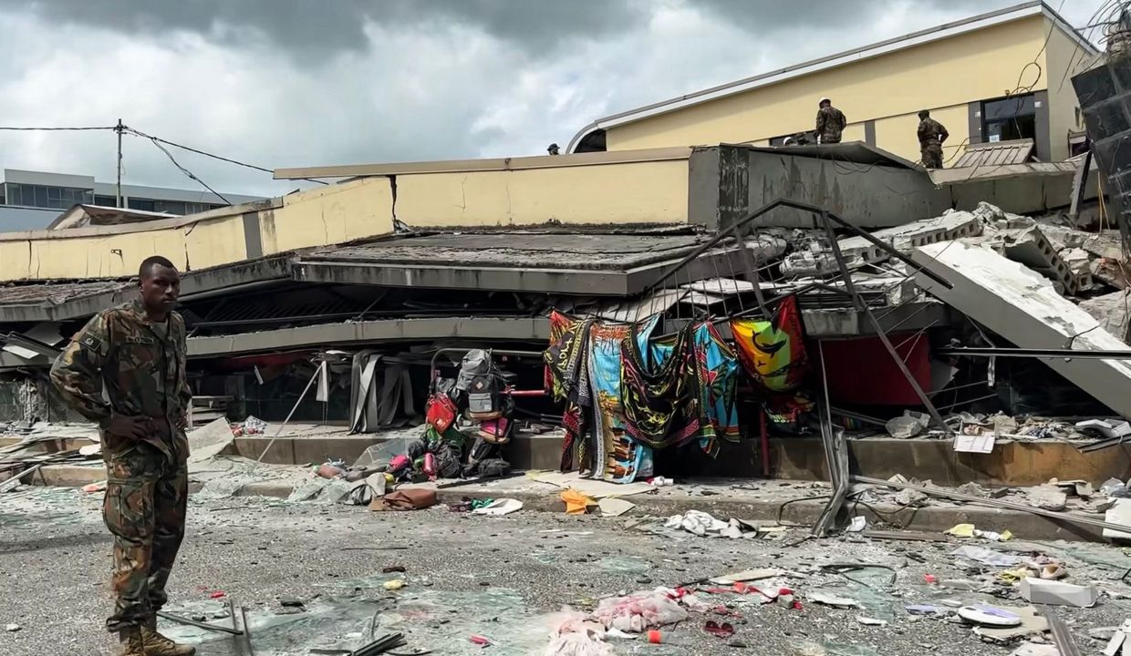 This screengrab taken from handout video footage posted on the Facebook account of Michael Thompson on December 17, 2024 shows a member of security inspecting a collapsed building in Vanuatu's capital Port Vila after a powerful earthquake hit the Pacific island. The 7.3-magnitude quake struck on December 17 at a depth of 57 kilometres (35 miles), some 30 kilometres off the coast of Efate, Vanuatu's main island, at 12:47 pm (0147 GMT), according to the US Geological Survey. - AFP