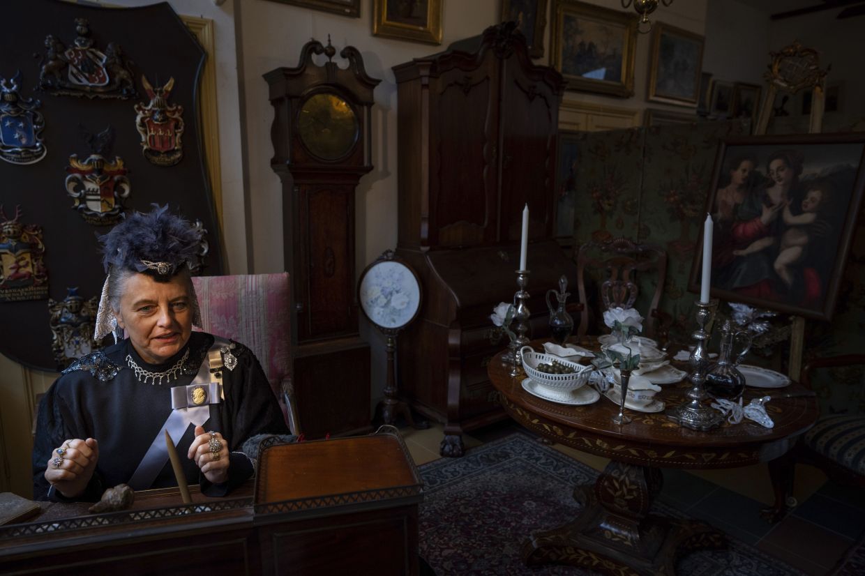 Sandra Nieland dressed as Queen Victoria is photographed as people in costumes from Charles Dickens' 19th-century English era take part in a Dickens Festival, in Deventer