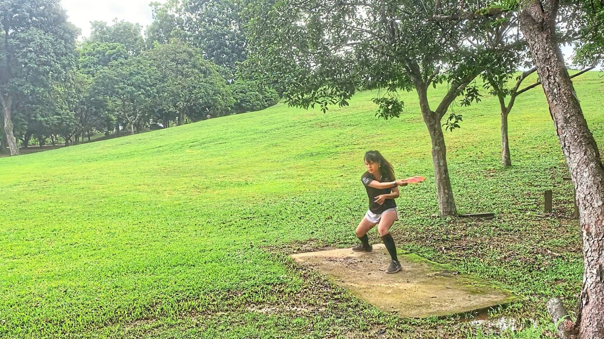 Just like golf: Jenna tees off at the 15th at the Pelangi Indah Disc Golf Course.