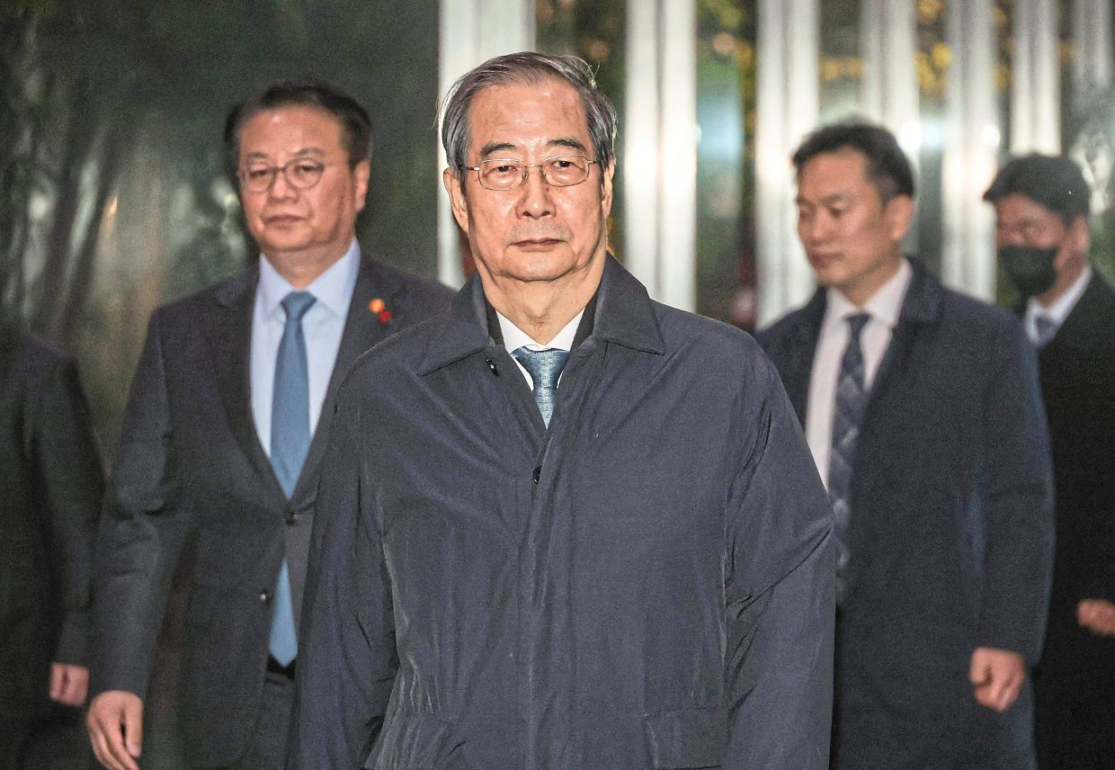 Han leaving the Government Complex in Seoul after his impeachment motion was passed.