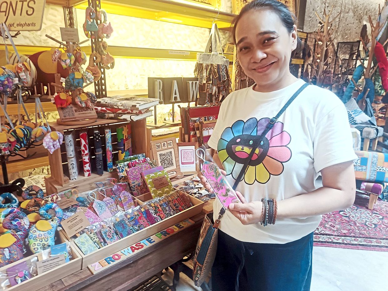 Leong turns batik fabric waste into functional products such as shopping bags (right) and finds the work therapeutic.
