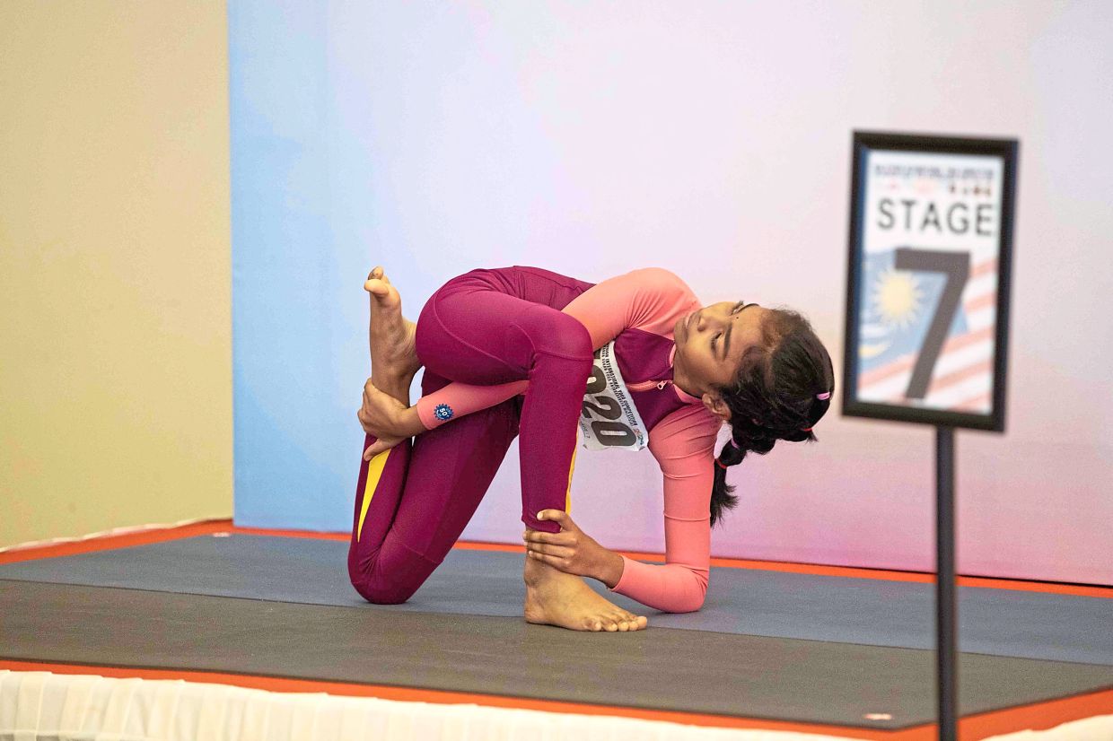 Competitors showcasing their flexibility and strength at the yoga competition.