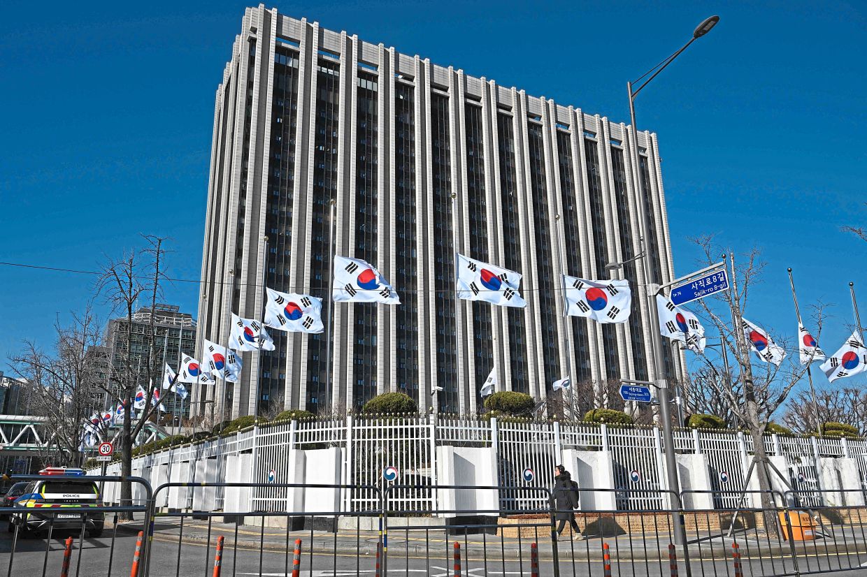 Mark of respect: South Korean national flags flying at half-mast at the Government Complex in Seoul. — AFP