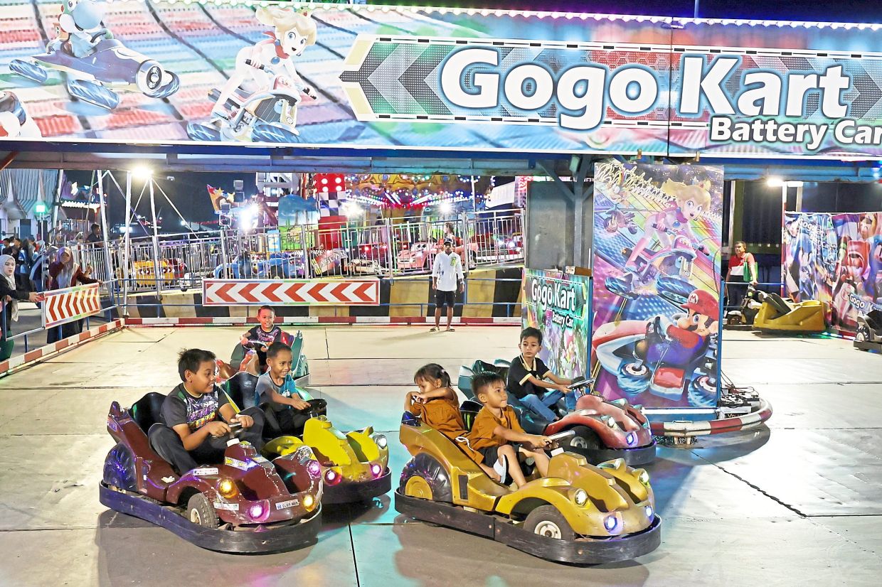 Kids enjoying bumper car rides at the fair.