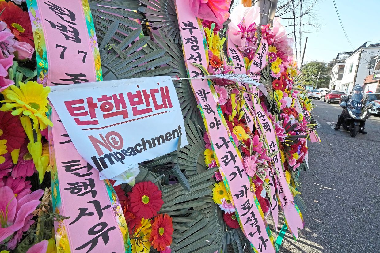 Impeachment impressions: Wreaths sent by supporters of impeached President Yoon displayed outside the Constitutional Court in Seoul. — AP 