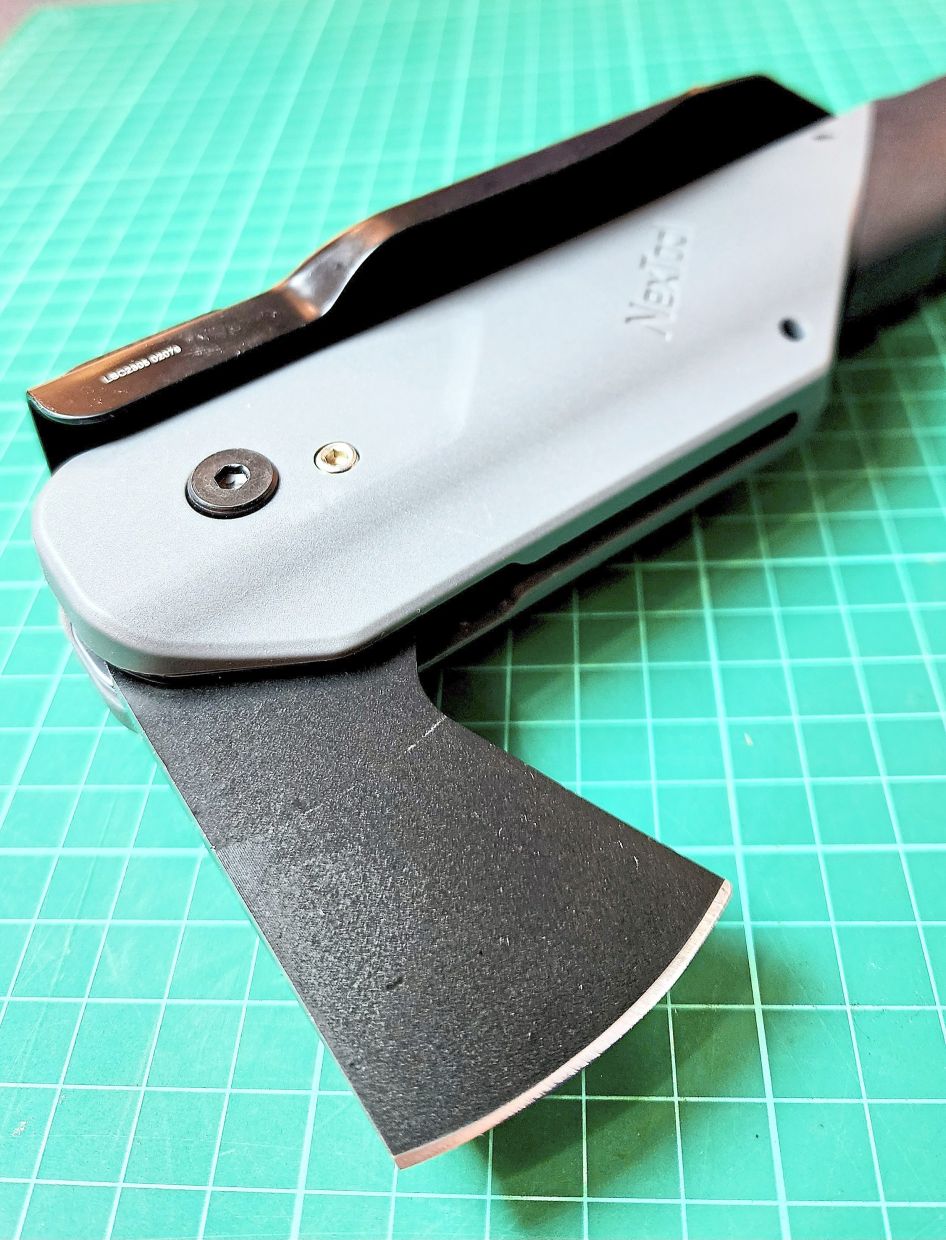 The shovel folds down and a small hatchet swings out.