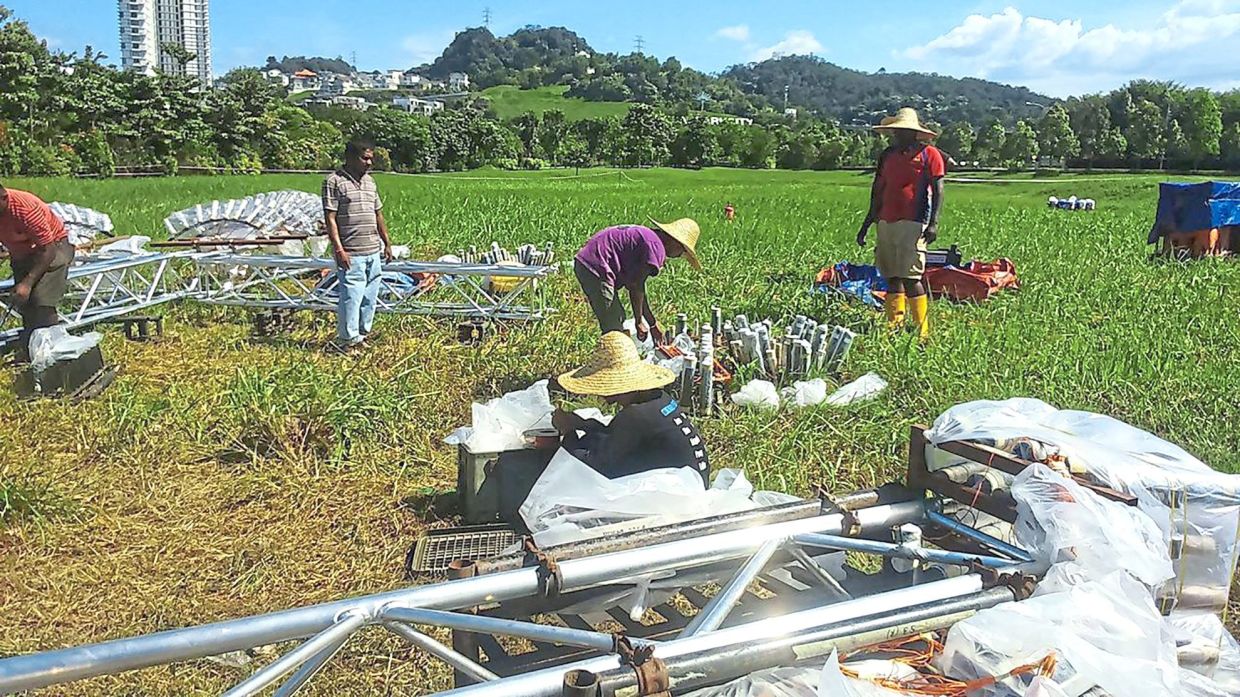 Workers setting up for a fireworks display for a developer in Kuala Lumpur. — Photos courtesy of Krishna Moorthy and Jeffry Bahary