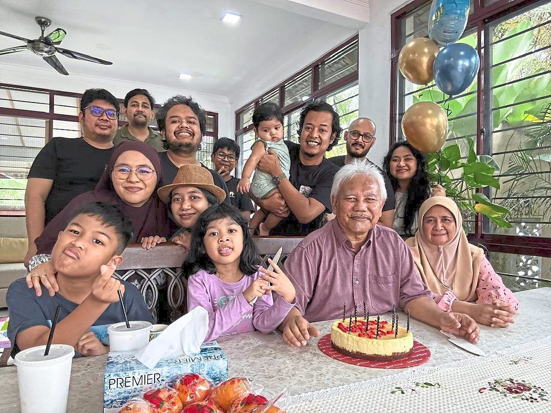 Season’s greetings: Mohd Tajuddin (seated, second from right), his wife (seated, right), his five children, three sons-in-law and four grandchildren celebrating his 63rd birthday.