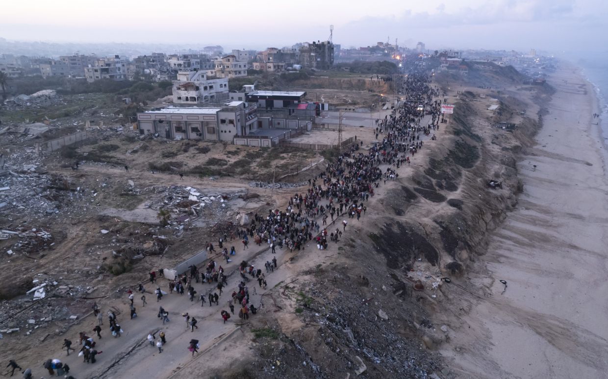 An aerial photograph taken by a drone shows displaced Palestinians return to their homes in the northern Gaza Strip, following Israel's decision to allow thousands of them to go back for the first time since the early weeks of the 15-month war with Hamas, Monday, Jan. 27, 2025. (AP Photo/ Mohammad Abu Samra)