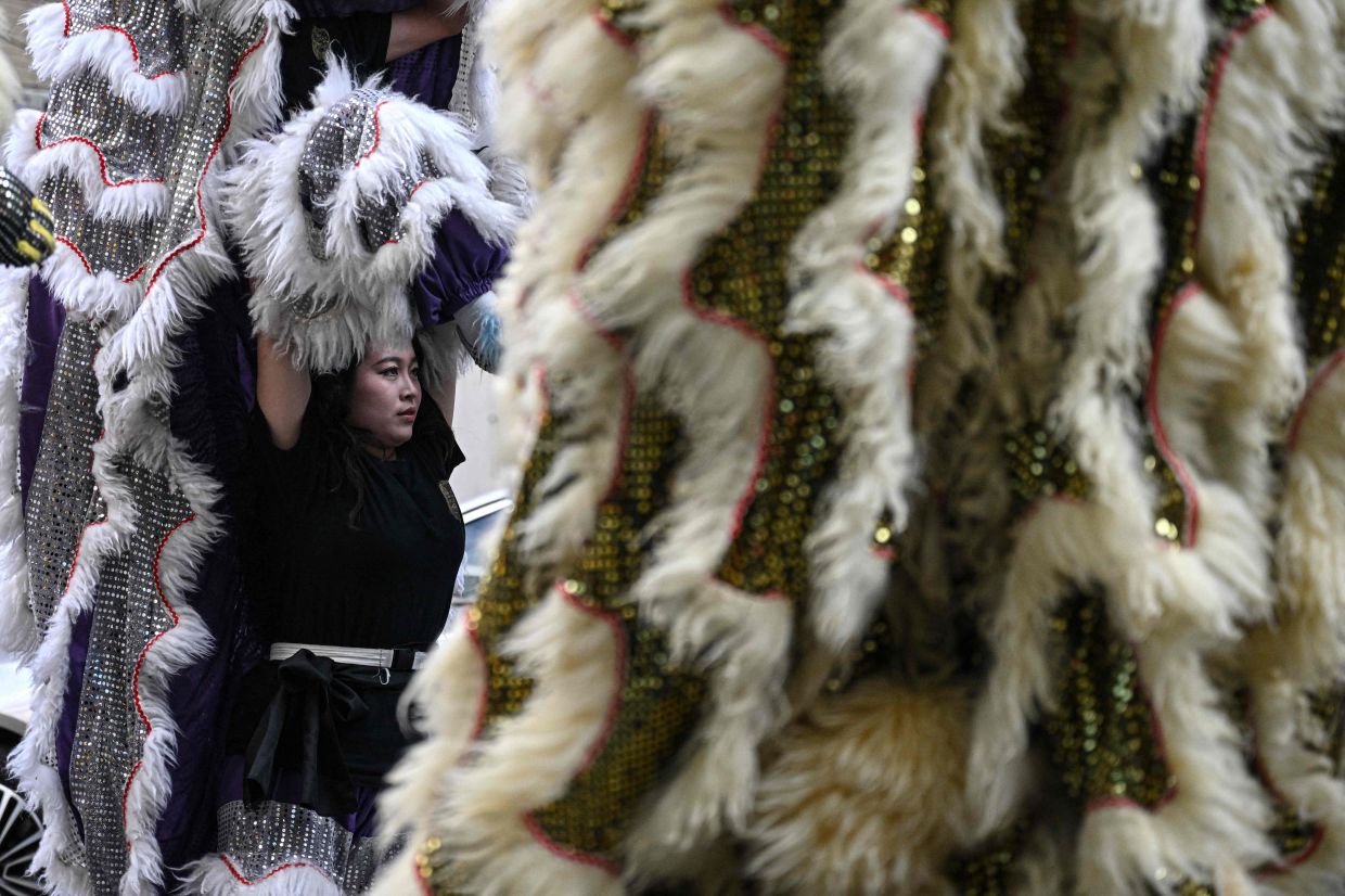 'Some say that a girl can't lead a lion. But it's my passion and it's up to me alone to take it on,' says performer Lin Xinmeng. Photo: AFP 