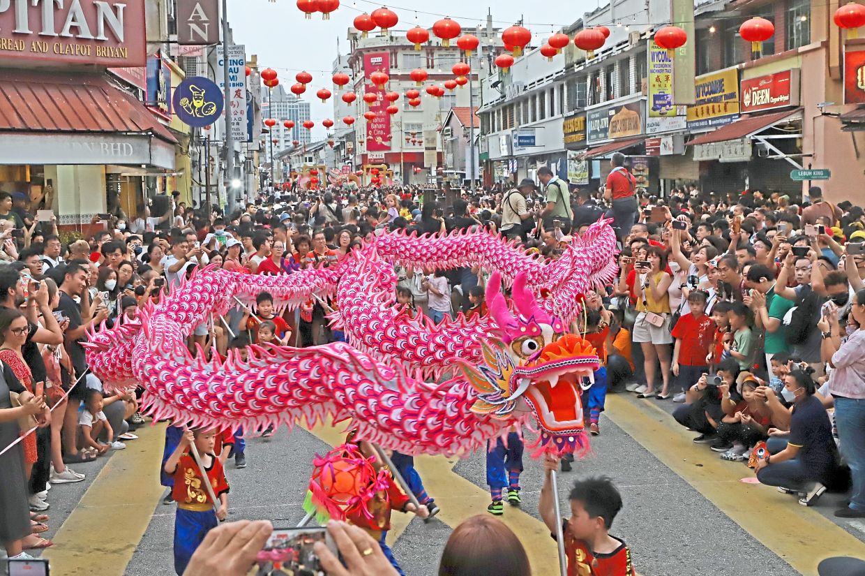 Festival-goers enjoying the special ‘Blessing of the Twin Dragons’ routine performed by Penang Chinese Girls High School (PCGHS) kindergarten dragon dance troupe during the 2024 Penang Chinese New Year Celebration or Miaohui in George Town. — Filepic