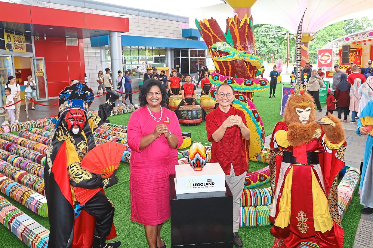 Lim (right) and the theme park’s sales and marketing director M. Thila with the Lego snake at the launch of the resort’s CNY celebrations.