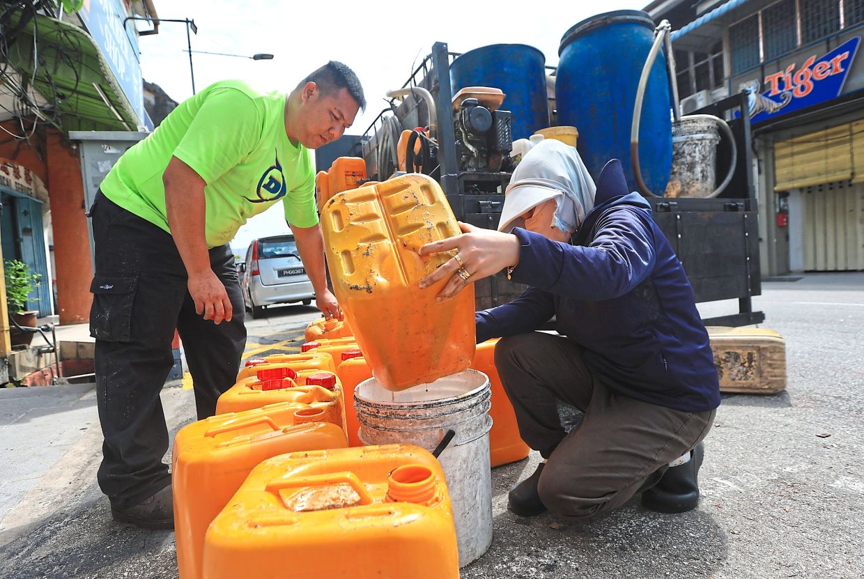 A recycling company collecting used cooking oil in Chulia Street. 