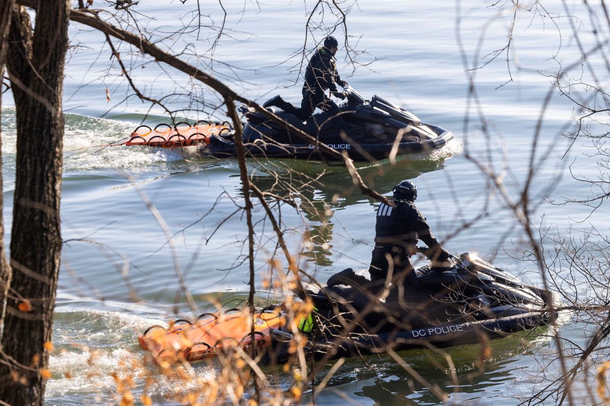 Police comb for debris and remains from the crash on Thursday. Photograph: Jim Lo Scalzo/EPA