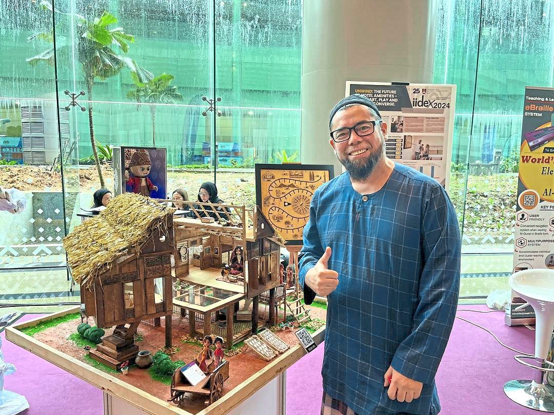 Rooted in tradition: Abu posing for a photo with the dollhouse.
