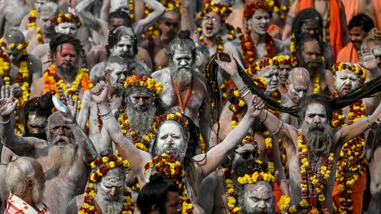 Naga Sadhus or Hindu holy men arrive in a procession to take a dip in Sangam, the confluence of Ganges, Yamuna and mythical Saraswati rivers, on an auspicious occasion of 'Mauni Amavasya' during the Maha Kumbh Mela festival in Prayagraj on Jan 29, 2025. — AFP