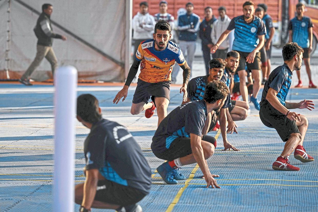 Pratik Waikar (centre), captain of India’s men’s kho kho team, takes part in selection trials for the Kho Kho World Cup in New Delhi. — AFP