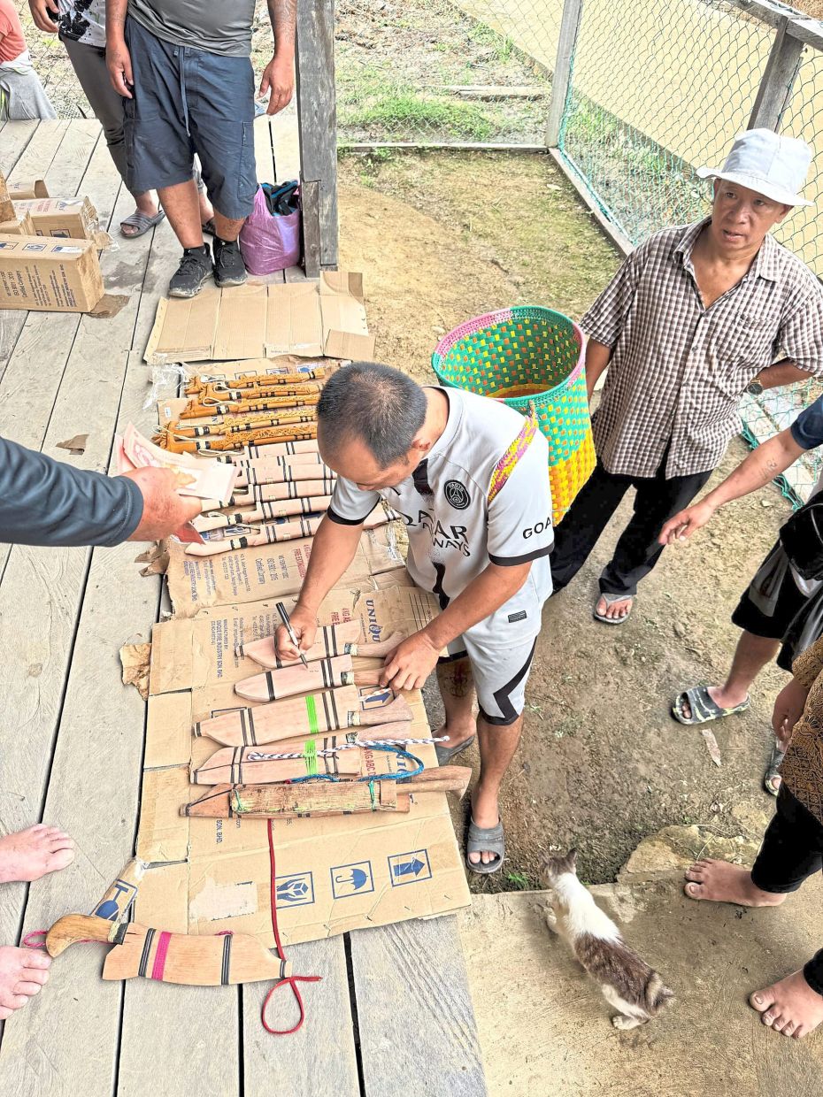 Penan villagers selling their handicrafts during the programme.