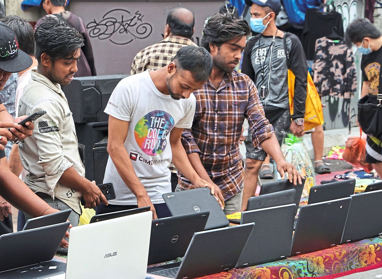 Shoppers comparing prices and specifications of refurbished laptops.