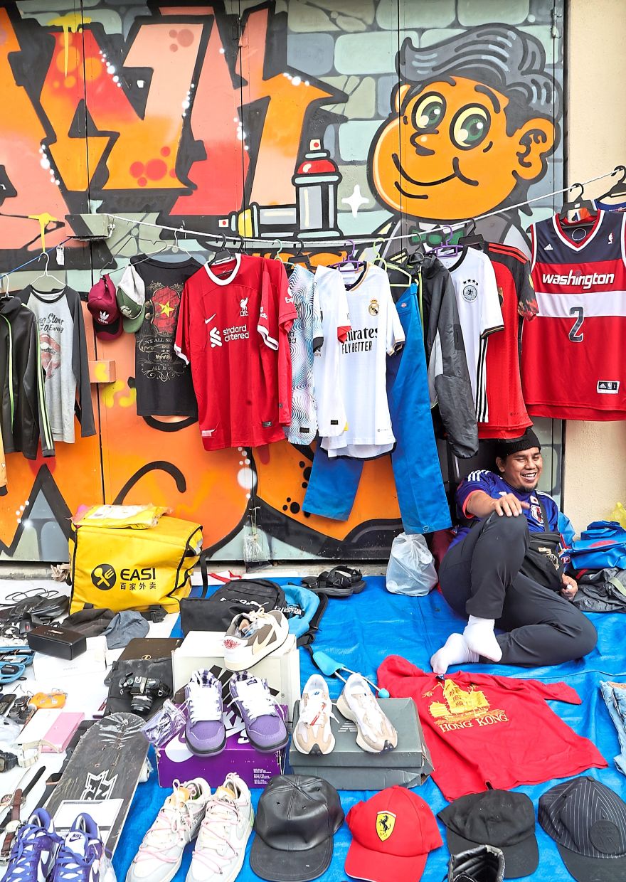 (Above) Colourful apparel including football jerseys, caps and sneakers for sale.  
